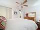 Bright bedroom with a king-size bed, dresser, and ceiling fan at 1012 Pearce Dr # 211, Clearwater, FL 33764