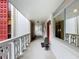 Light-filled hallway with red door and potted plant at 1012 Pearce Dr # 211, Clearwater, FL 33764