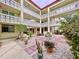 Peaceful courtyard with brickwork, gravel, and tropical plants at 1012 Pearce Dr # 211, Clearwater, FL 33764