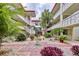 Landscaped courtyard with brick path and fountain at 1012 Pearce Dr # 211, Clearwater, FL 33764