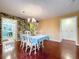 Dining room with hardwood floors, a chandelier, and a table set for four at 1012 Pearce Dr # 211, Clearwater, FL 33764