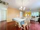 Bright dining room featuring hardwood floors, a chandelier, and a table set for four at 1012 Pearce Dr # 211, Clearwater, FL 33764