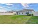 House back view with a sliding glass door and side yard at 10399 Gliding Eagle Way, Land O Lakes, FL 34638