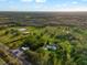 Aerial view of spacious land with mature trees with road frontage at 10601 Paul S Buchman, Plant City, FL 33565