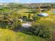 Expansive aerial view of property with a single Gathering home, barn, and a mix of open fields and wooded areas at 10601 Paul S Buchman, Plant City, FL 33565