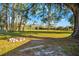 Expansive backyard featuring a rustic fire pit, providing an inviting space for relaxation and outdoor enjoyment at 10601 Paul S Buchman, Plant City, FL 33565