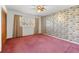 Large bedroom featuring vintage wallpaper, tan carpet, and neutral curtains at 10601 Paul S Buchman, Plant City, FL 33565