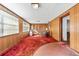 Large living room with wood paneling, a vintage TV, shelving, and windows at 10601 Paul S Buchman, Plant City, FL 33565