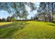 Expansive green lawn with mature trees and Spanish moss provides a picturesque setting for this tranquil property at 10601 Paul S Buchman, Plant City, FL 33565