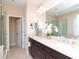 Elegant bathroom with double vanity, large mirror, and a walk-in shower at 11125 Winthrop Lake Dr, Riverview, FL 33578