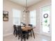 Charming dining area with rustic wood table and modern chandelier at 11125 Winthrop Lake Dr, Riverview, FL 33578