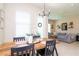 Open concept dining area with wood table and view into living room at 11125 Winthrop Lake Dr, Riverview, FL 33578