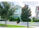 Two-story light green house with white picket fence, landscaping, and street view at 11125 Winthrop Lake Dr, Riverview, FL 33578