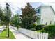 Light green house with white picket fence and landscaping at 11125 Winthrop Lake Dr, Riverview, FL 33578