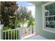 Front porch of a light green house with white railing at 11125 Winthrop Lake Dr, Riverview, FL 33578