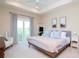 Spacious main bedroom with king-size bed and access to balcony at 11125 Winthrop Lake Dr, Riverview, FL 33578