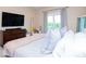 Main bedroom with king-size bed, and private balcony access at 11125 Winthrop Lake Dr, Riverview, FL 33578