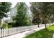 Side yard of light green house with white picket fence and landscaping at 11125 Winthrop Lake Dr, Riverview, FL 33578