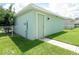 Small green storage shed with a white door at 11125 Winthrop Lake Dr, Riverview, FL 33578