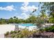 Community pool with lounge chairs and lush landscaping at 11125 Winthrop Lake Dr, Riverview, FL 33578