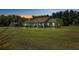 Single-story home with large yard at dusk at 11307 Wagon Trail Run, Lithia, FL 33547