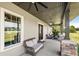 Covered porch with seating area and ceiling fan at 11307 Wagon Trail Run, Lithia, FL 33547