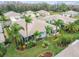 Aerial view showcasing a house with a sunroom and a beautifully landscaped backyard at 11447 Golf Round Dr, New Port Richey, FL 34654