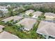 Aerial view showing a house with a landscaped backyard and palm trees at 11447 Golf Round Dr, New Port Richey, FL 34654