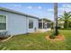 Screened patio and lush landscaping along the side of the home at 11447 Golf Round Dr, New Port Richey, FL 34654