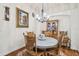 Charming dining room with hardwood floors and round table at 11447 Golf Round Dr, New Port Richey, FL 34654