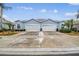 Light blue duplex home with two-car garages and landscaped yards at 11447 Golf Round Dr, New Port Richey, FL 34654