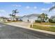 Street view of multiple light blue houses with two-car garages at 11447 Golf Round Dr, New Port Richey, FL 34654