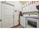 Convenient laundry room with washer, dryer, and cabinets at 11447 Golf Round Dr, New Port Richey, FL 34654