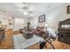 Living room with hardwood floors, red leather couches, and a fireplace at 11447 Golf Round Dr, New Port Richey, FL 34654