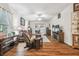 Living room with hardwood floors, red leather couches, and a fireplace at 11447 Golf Round Dr, New Port Richey, FL 34654