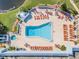 Aerial view of resort-style pool with numerous lounge chairs at 11447 Golf Round Dr, New Port Richey, FL 34654