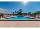 Relaxing community pool with surrounding lounge chairs at 11447 Golf Round Dr, New Port Richey, FL 34654