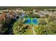 Two well-maintained tennis courts nestled in a serene landscape at 11447 Golf Round Dr, New Port Richey, FL 34654