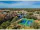 Aerial view of two tennis courts near a lake at 11447 Golf Round Dr, New Port Richey, FL 34654