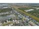 Aerial view of a residential area featuring houses near a lake and undeveloped land at 11614 Brighton Knoll Loop, Riverview, FL 33579