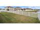 Spacious backyard with a white fence and a view of a lake at 11614 Brighton Knoll Loop, Riverview, FL 33579