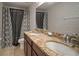 Bathroom with double vanity, granite countertop, and patterned curtains at 11614 Brighton Knoll Loop, Riverview, FL 33579