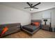 Bedroom with wood-look floors, ceiling fan, and modern furniture at 11614 Brighton Knoll Loop, Riverview, FL 33579