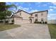 Two-story house with a three-car garage and landscaping at 11614 Brighton Knoll Loop, Riverview, FL 33579