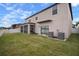 Back exterior of house with large yard and screened porch at 11614 Brighton Knoll Loop, Riverview, FL 33579