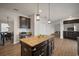 Kitchen island with granite countertop and dark cabinetry at 11614 Brighton Knoll Loop, Riverview, FL 33579