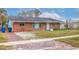 Brick ranch home with a well-maintained lawn at 120 80Th N Ave, St Petersburg, FL 33702