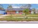 Brick home with a well-maintained lawn at 120 80Th N Ave, St Petersburg, FL 33702