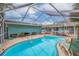 Relaxing kidney-shaped pool with patio and lounge chairs at 120 80Th N Ave, St Petersburg, FL 33702