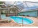 Kidney-shaped pool with screened enclosure at 120 80Th N Ave, St Petersburg, FL 33702